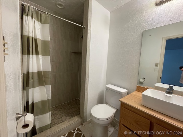 bathroom with vanity, toilet, tile patterned floors, and a shower with curtain