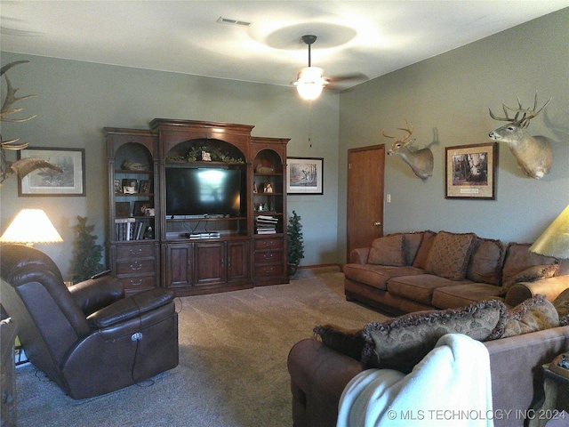 carpeted living room with ceiling fan