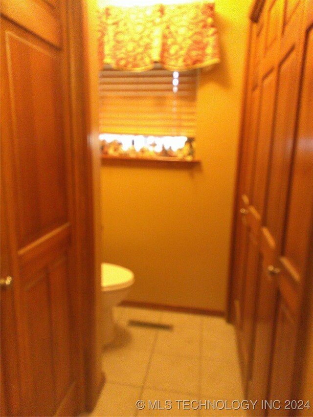 bathroom with tile patterned flooring and toilet