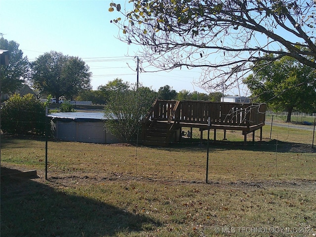 view of yard with a swimming pool side deck