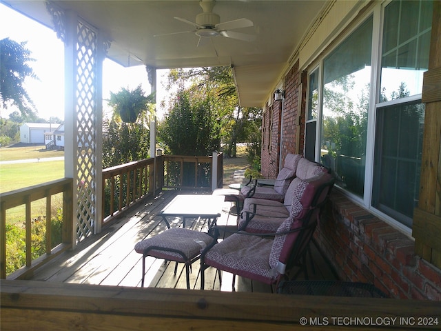 wooden deck featuring ceiling fan