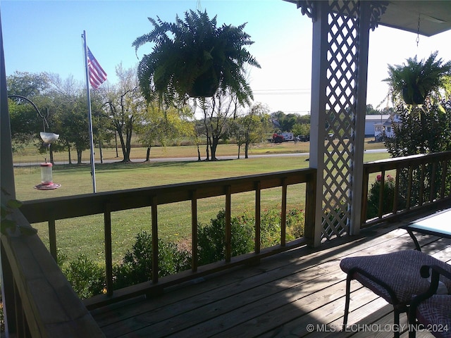 wooden deck featuring a yard