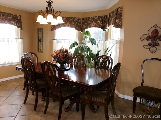 dining space with tile patterned flooring and a chandelier