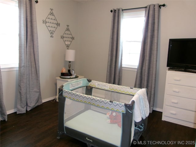 bedroom with dark hardwood / wood-style floors