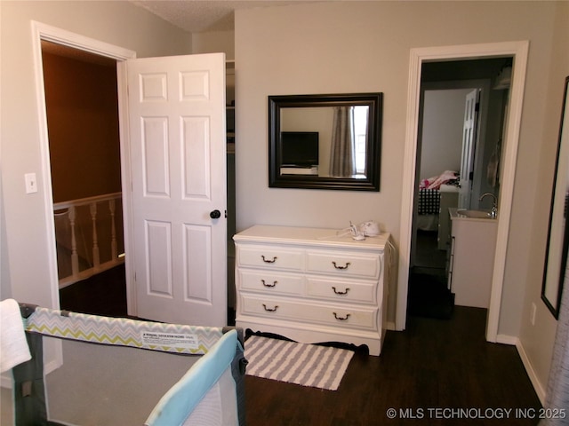 bedroom with dark hardwood / wood-style floors