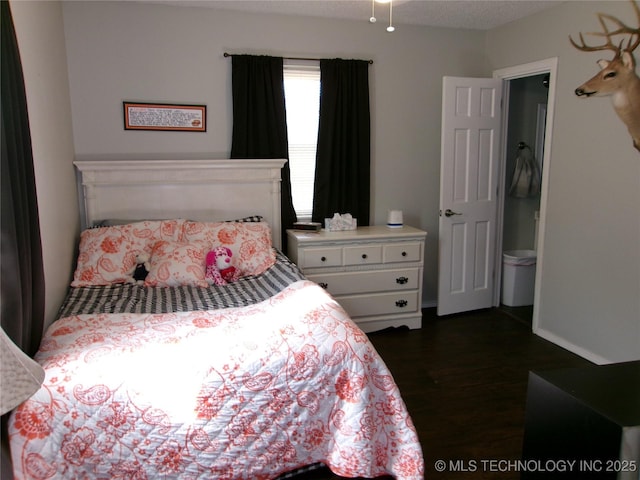 bedroom with dark wood-type flooring