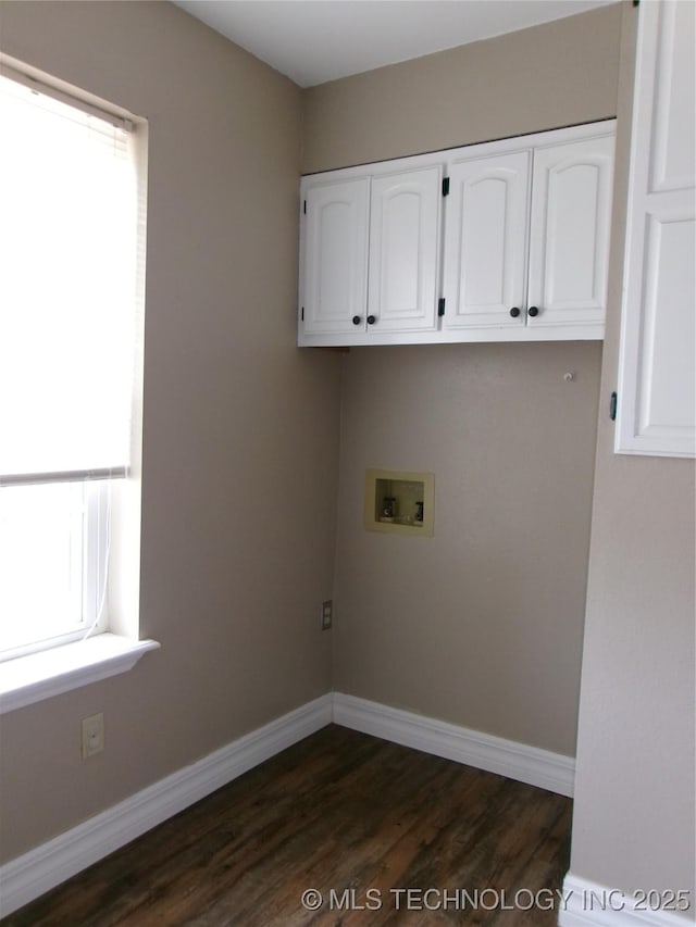 laundry area featuring dark hardwood / wood-style flooring, hookup for a washing machine, and cabinets