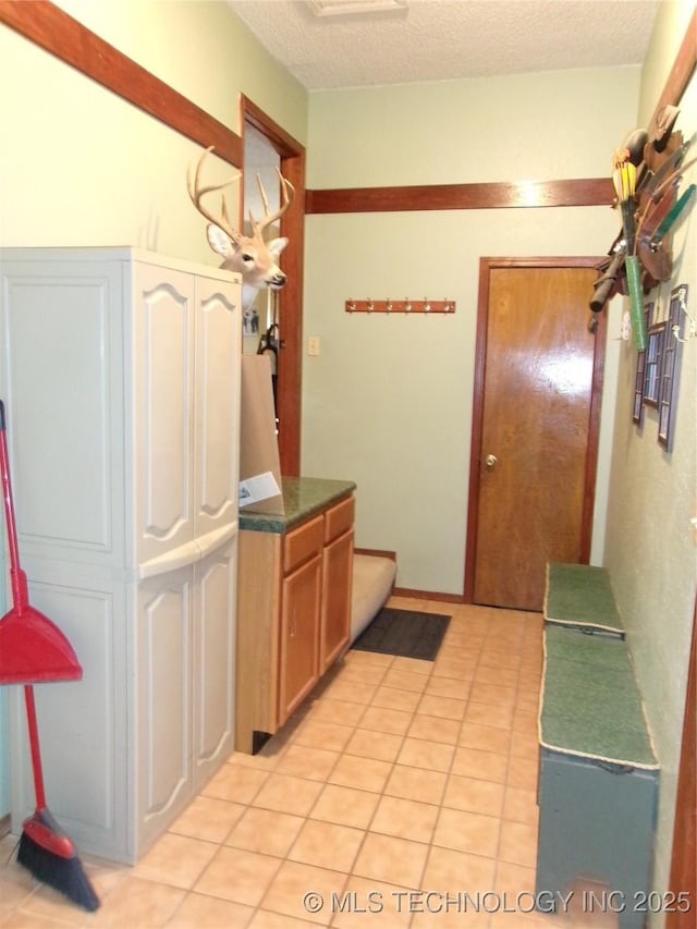 kitchen featuring light tile patterned flooring and a textured ceiling