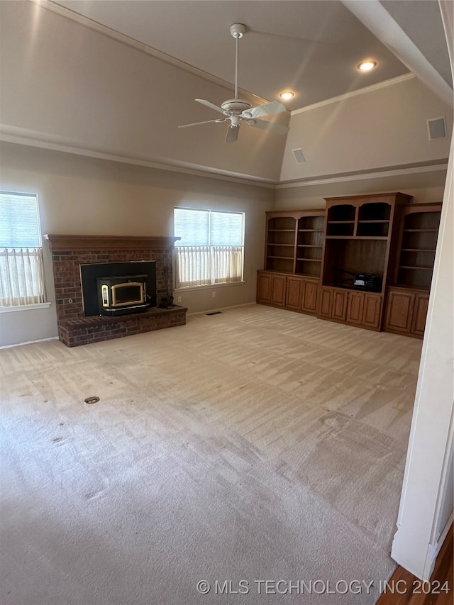 unfurnished living room with lofted ceiling, light colored carpet, and ceiling fan