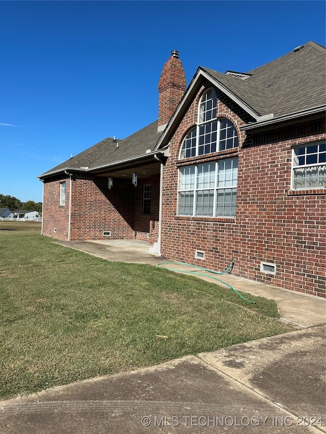 back of property featuring a yard and a patio area