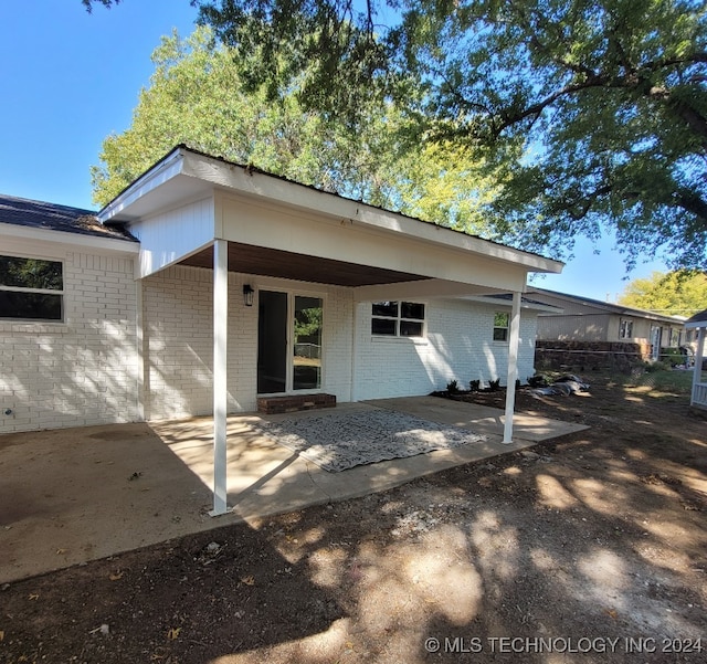 rear view of property featuring a patio area