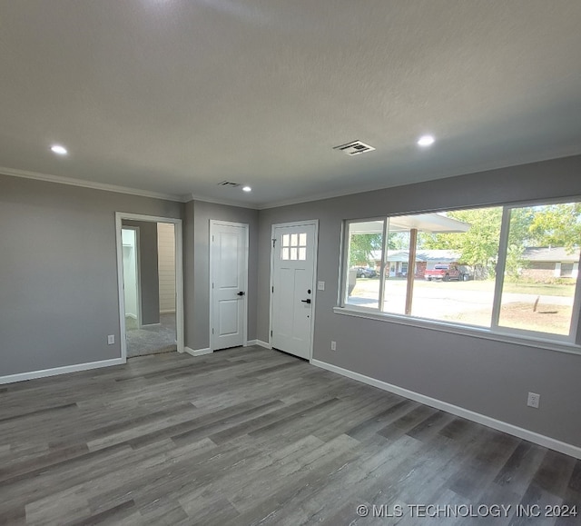 foyer featuring crown molding, hardwood / wood-style flooring, and a textured ceiling