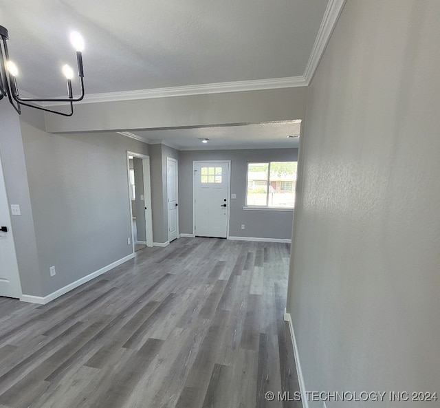 foyer featuring hardwood / wood-style flooring and crown molding