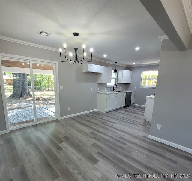 kitchen featuring ornamental molding, hardwood / wood-style flooring, stainless steel dishwasher, and white cabinetry