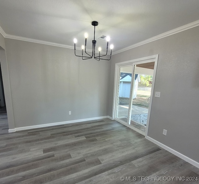 unfurnished dining area featuring ornamental molding, a notable chandelier, and dark wood-type flooring