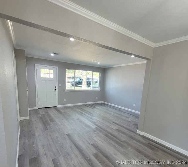 foyer entrance featuring wood-type flooring and ornamental molding