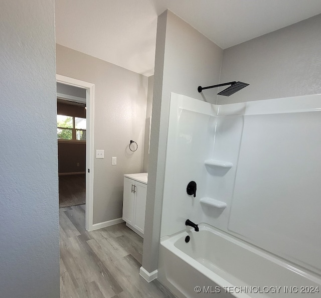 bathroom featuring shower / bath combination, wood-type flooring, and vanity