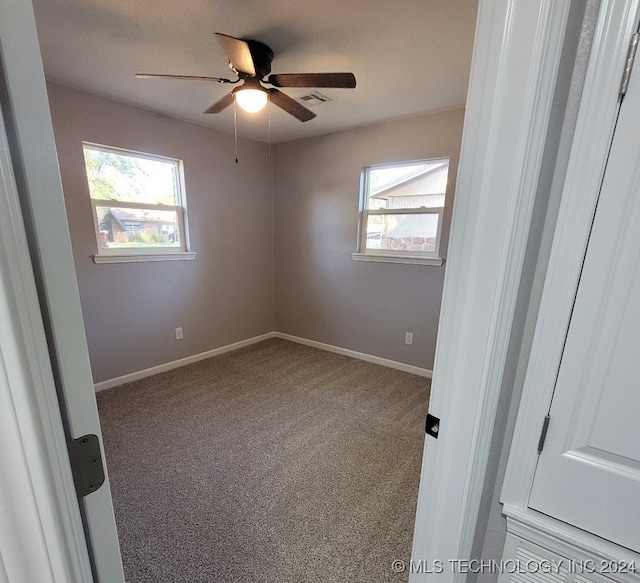 spare room with a healthy amount of sunlight, ceiling fan, and carpet floors