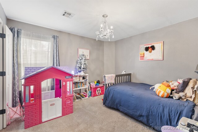 bedroom with a notable chandelier and carpet flooring