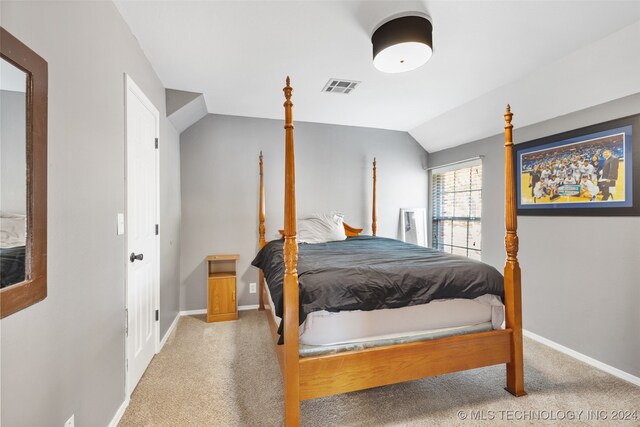 bedroom featuring lofted ceiling and carpet flooring