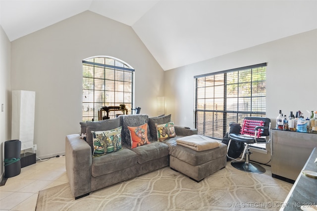 tiled living room with vaulted ceiling and a healthy amount of sunlight