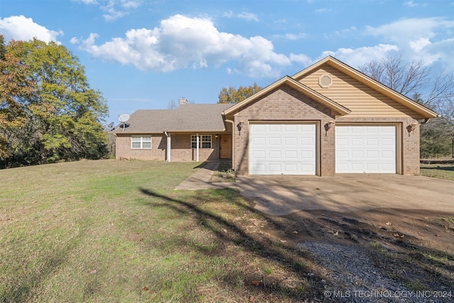 single story home with a garage and a front lawn