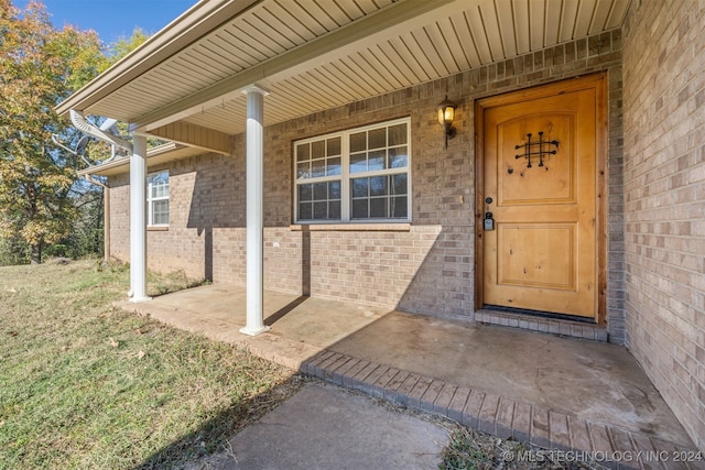 view of exterior entry with a porch