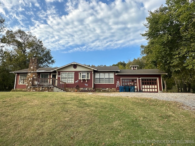 view of front of property with a front yard and a garage