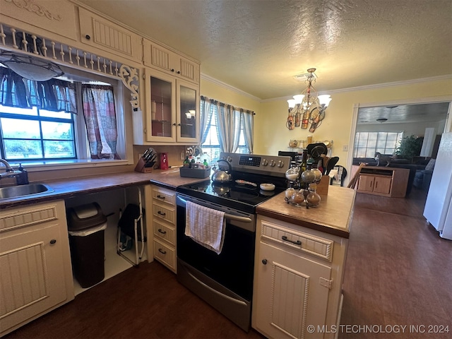 kitchen with electric stove, sink, dark wood-type flooring, and a textured ceiling