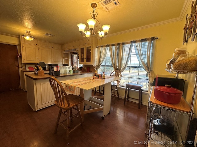 kitchen featuring hanging light fixtures, wood counters, dark hardwood / wood-style flooring, crown molding, and a textured ceiling