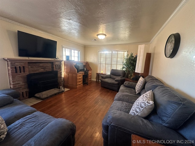 living room with a fireplace, ornamental molding, a textured ceiling, and hardwood / wood-style flooring