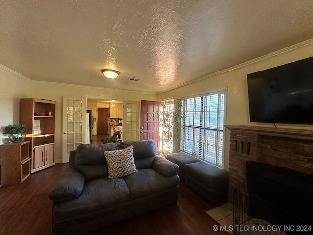 living room with a fireplace, crown molding, a textured ceiling, and dark wood-type flooring