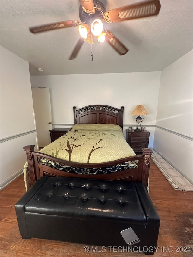 bedroom with ceiling fan and dark hardwood / wood-style flooring