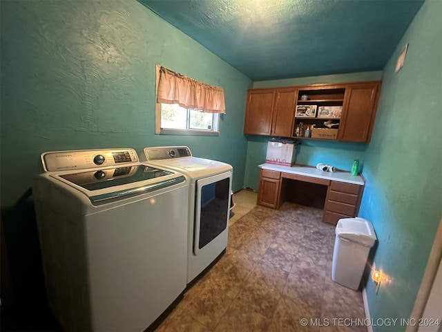 washroom featuring washer and clothes dryer and cabinets