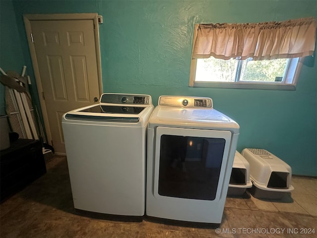 washroom with tile patterned floors and washing machine and clothes dryer