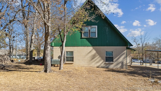 view of side of home featuring concrete block siding