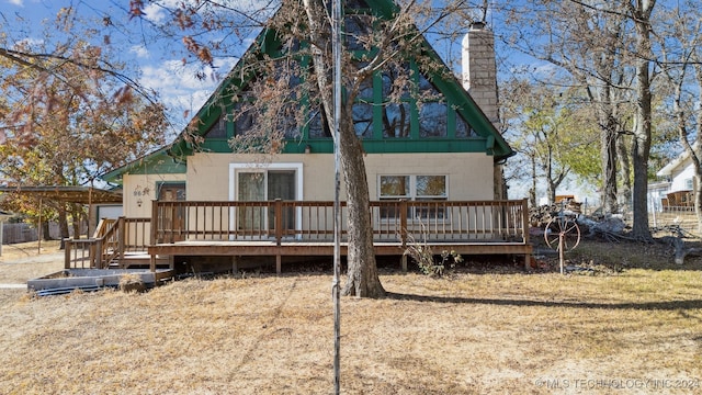 back of house featuring a wooden deck