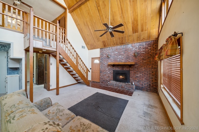 carpeted living room featuring a brick fireplace, ceiling fan, wooden ceiling, high vaulted ceiling, and brick wall