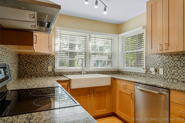 kitchen featuring stainless steel dishwasher, ventilation hood, light stone counters, and backsplash