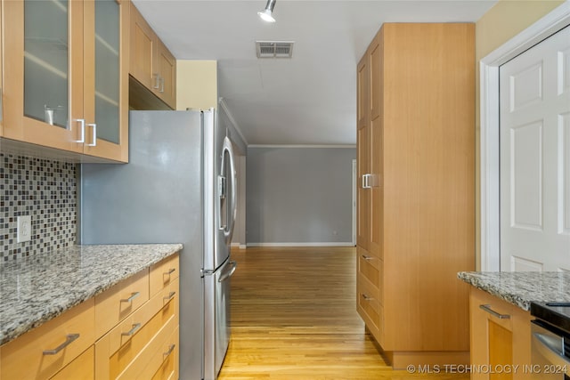 kitchen featuring light hardwood / wood-style flooring, backsplash, ornamental molding, appliances with stainless steel finishes, and light stone counters