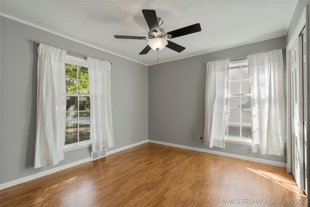 spare room featuring light hardwood / wood-style floors, ornamental molding, and ceiling fan