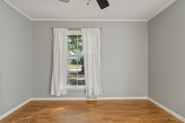 spare room featuring crown molding, hardwood / wood-style floors, and ceiling fan