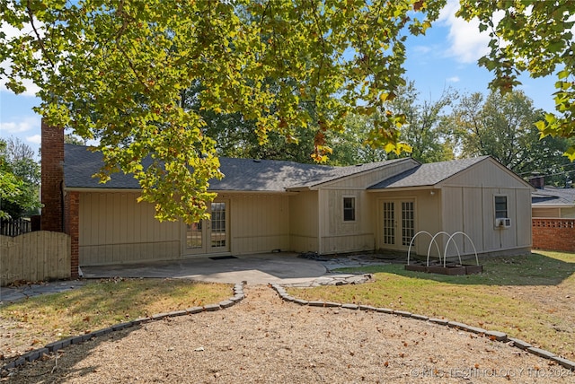 rear view of property with french doors, a patio area, and cooling unit