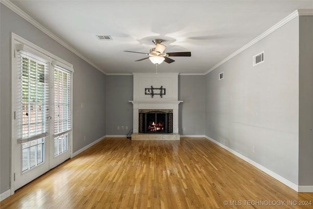 unfurnished living room with a fireplace, ornamental molding, light wood-type flooring, and ceiling fan