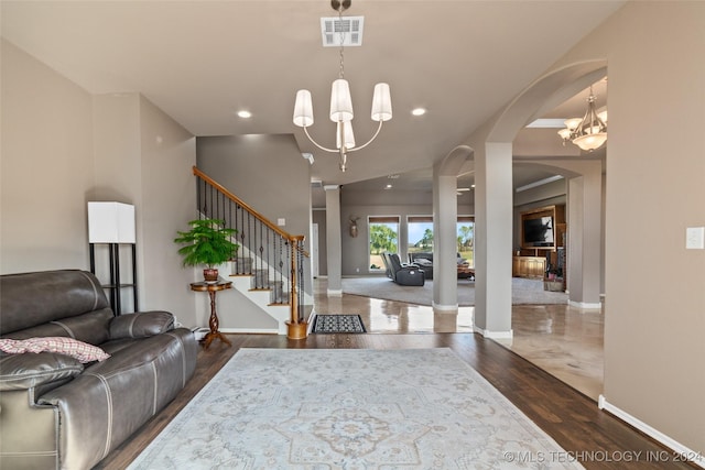 foyer entrance featuring a notable chandelier and dark hardwood / wood-style floors