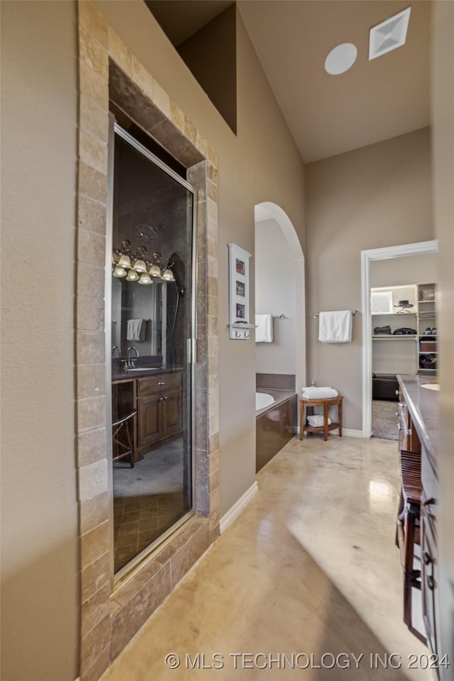 bathroom featuring concrete floors and shower with separate bathtub