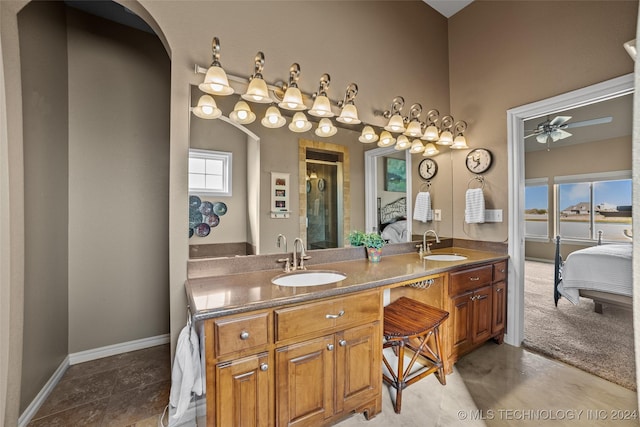 bathroom featuring vanity, a shower with shower door, and ceiling fan