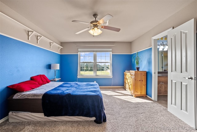 bedroom featuring connected bathroom, light carpet, and ceiling fan