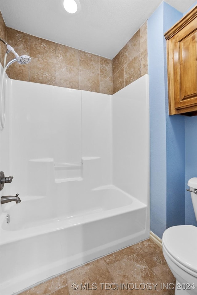 bathroom featuring toilet and bathing tub / shower combination