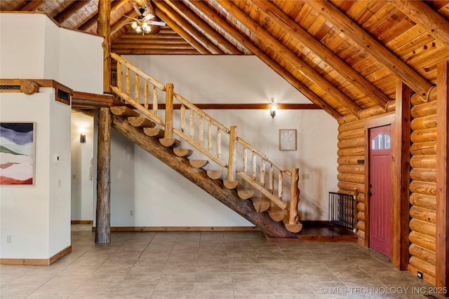 interior space featuring high vaulted ceiling, rustic walls, ceiling fan, wood ceiling, and beam ceiling